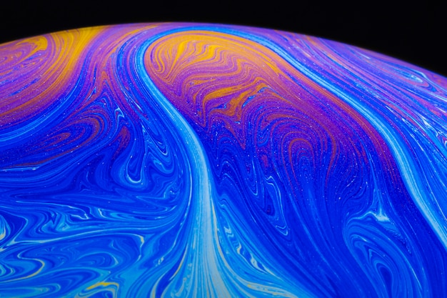 Free photo abstract vibrant rippled soap bubble on black background