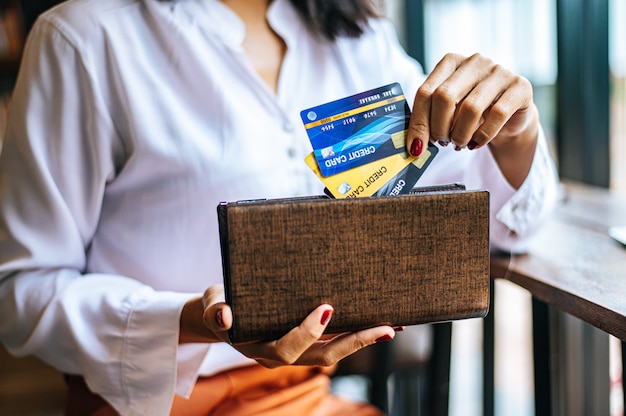 Accepting credit cards from a brown purse to pay for goods