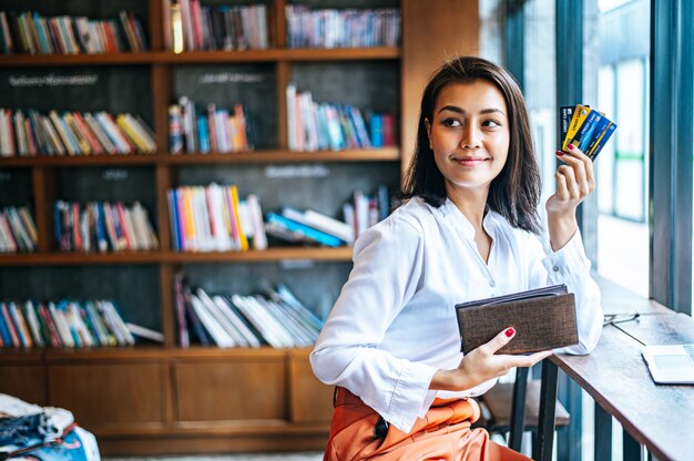 Accepting credit cards from a brown purse to pay for goods