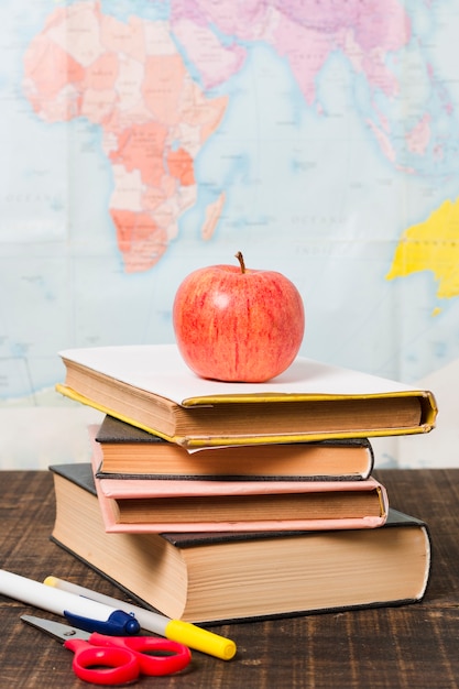 Accesories and books in front of world map