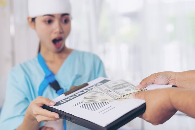 Accident patients injury  woman on Patient's bed in hospital  holding us dollar bills feel happy from getting insurance money From insurance companies- medical concept