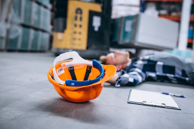 Free photo an accident at a warehouse, man on floor