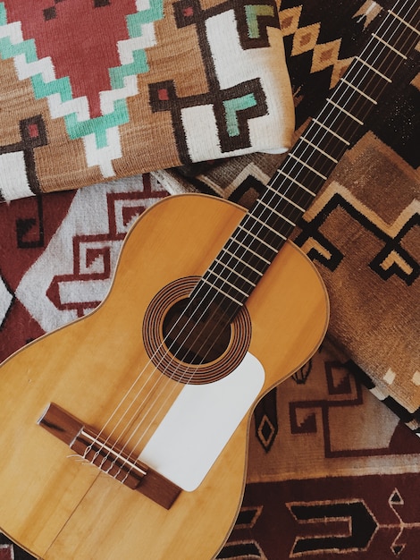 Acoustic guitar on a patterned blanket