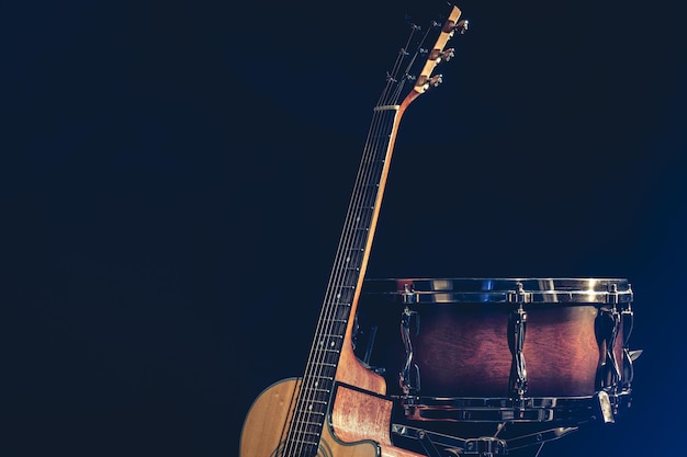 Free photo acoustic guitar and snare drum on a black background isolated