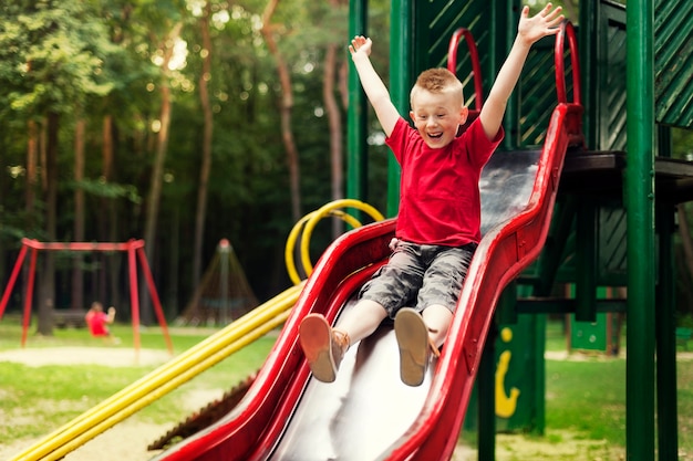 Active boy sliding down