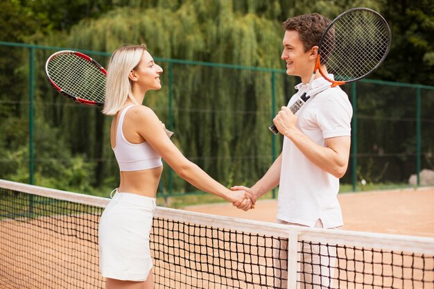 Active couple ready to play tennis