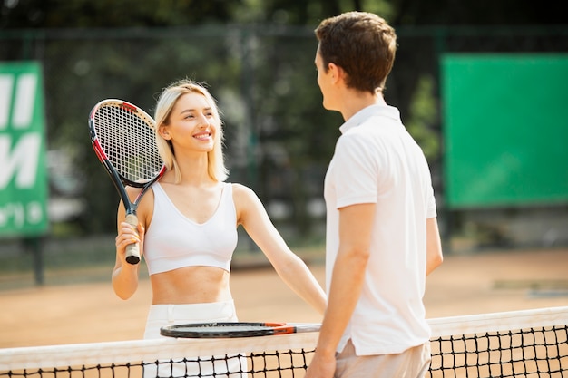 Free photo active couple on the tennis court