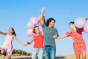 Free photo active family with balloons having fun