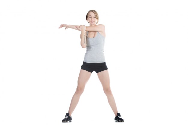 Active girl stretching her left arm
