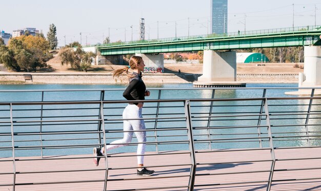 Active healthy female runner jogging at outdoor