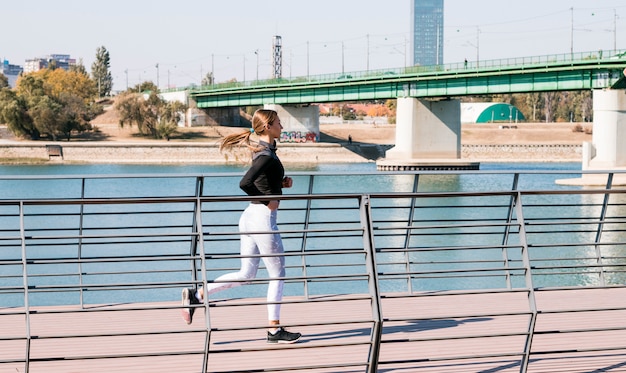 Active healthy female runner jogging at outdoor