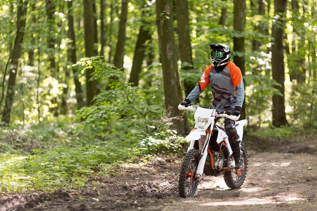 Active man riding motorcycle in the forrest