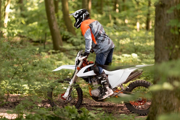 Active man riding motorcycle in the forrest