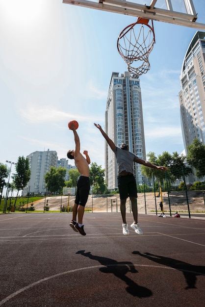 Active men playing basketball long shot
