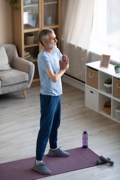 Active senior man training at home