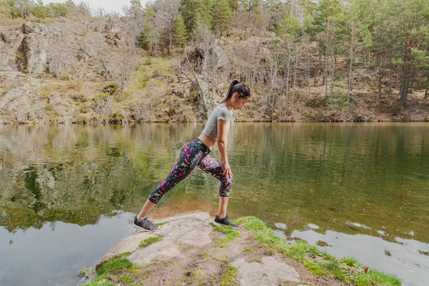 Active teen doing stretching outdoors