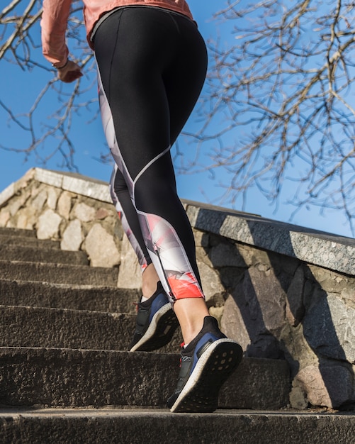 Active woman running on the stairs