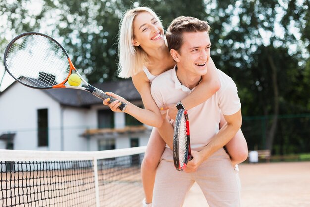 Active young couple playing tennis