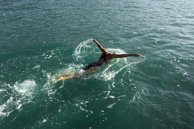 Active young lady enjoying swimming