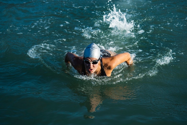 Active young lady enjoying swimming