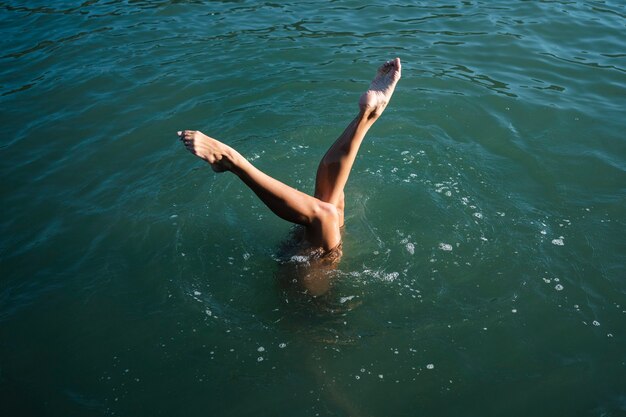 Active young lady enjoying swimming