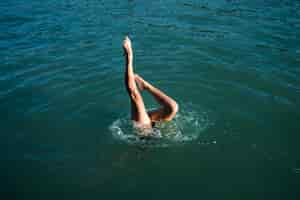 Free photo active young lady enjoying swimming