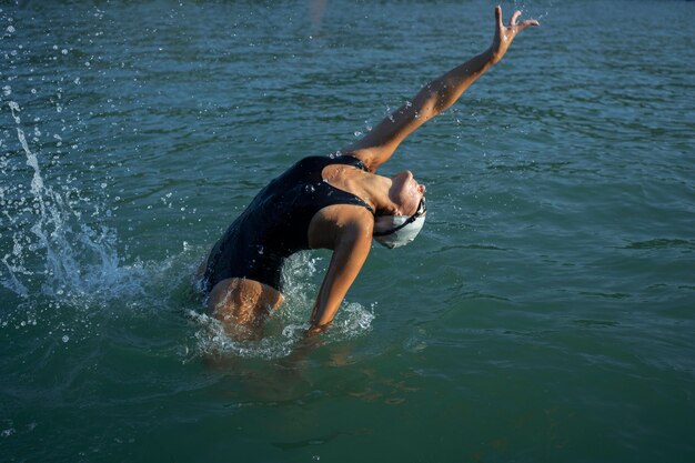 Active young lady enjoying swimming