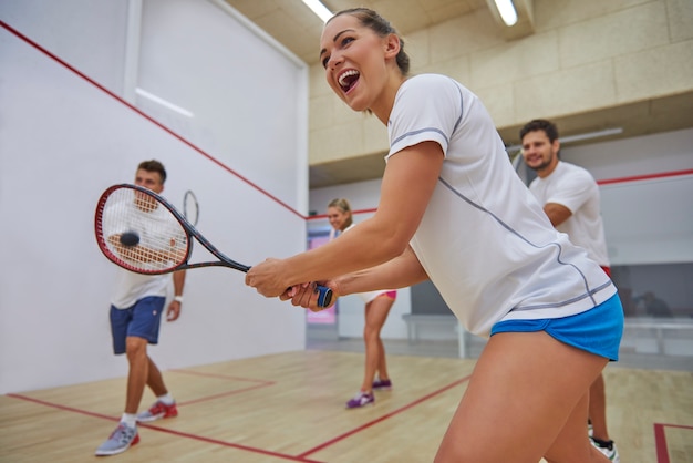 Free photo active young people playing squash