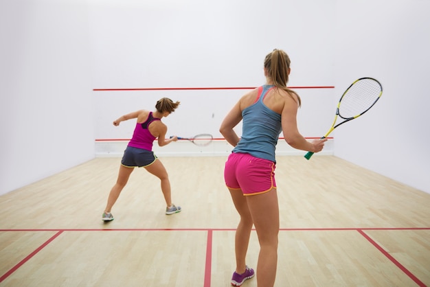 Active young people playing squash