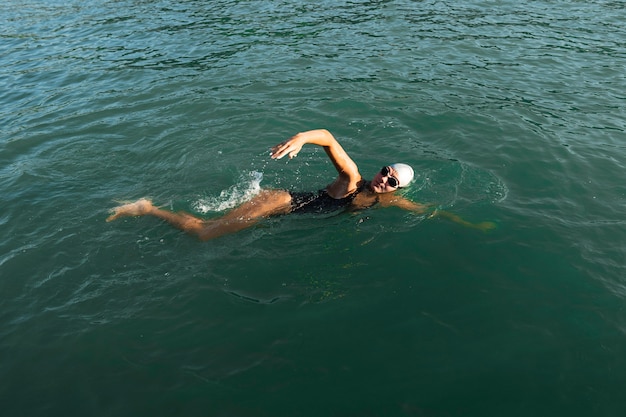 Active young woman enjoying swimming