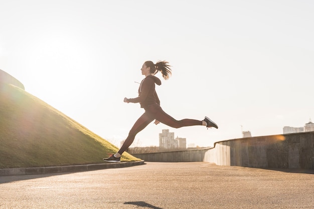 Foto gratuita giovane donna attiva che corre all'aperto