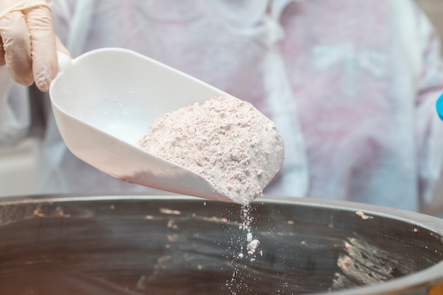 Adding all purpose flour into pan