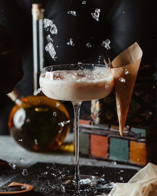 Adding minced ice cubes into coconut cocktail glass