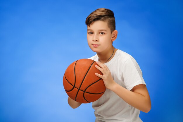 Adorable 11 year old boy child with basketball ball