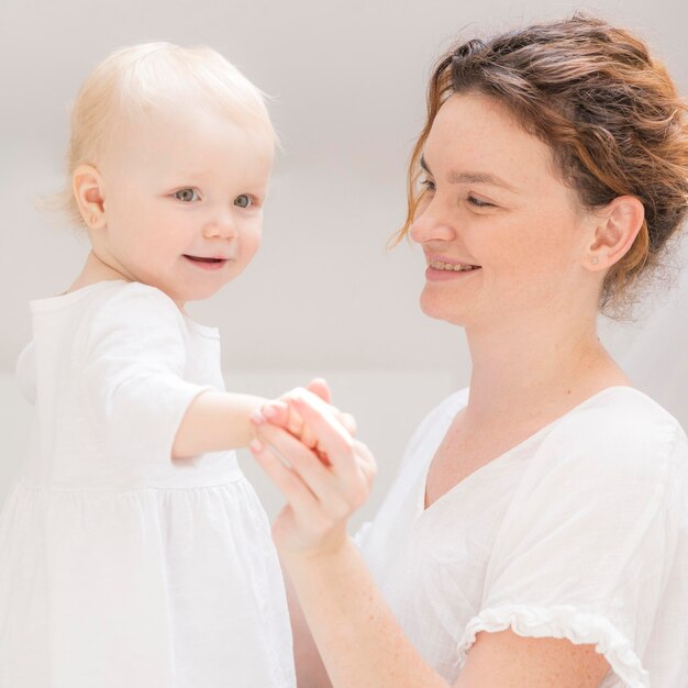 Adorable baby girl enjoying time with mom