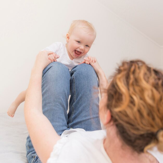 Adorable baby girl playing with mom