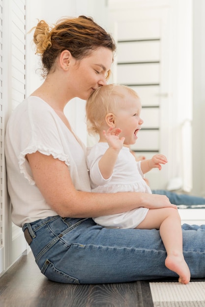 Adorable baby girl playing with mother