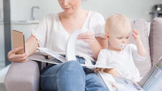 Adorable baby girl together with mother at home