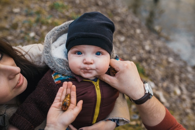 Adorable baby on hands of mother