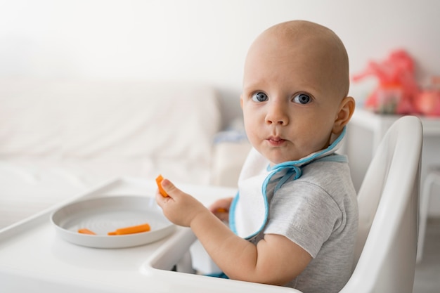 Adorable baby playing with food