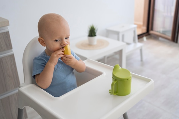 Adorable baby playing with food