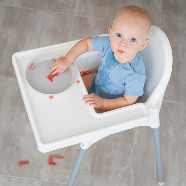 Free photo adorable baby playing with food