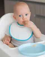 Free photo adorable baby playing with food