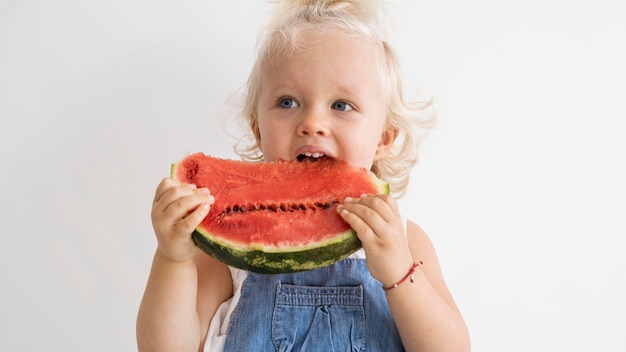 Free photo adorable baby playing with food