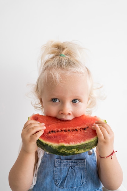 Adorable baby playing with food