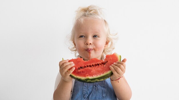 Adorable baby playing with food