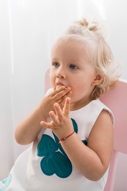 Adorable baby playing with food