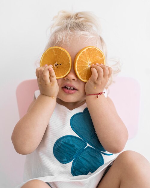 Adorable baby playing with food