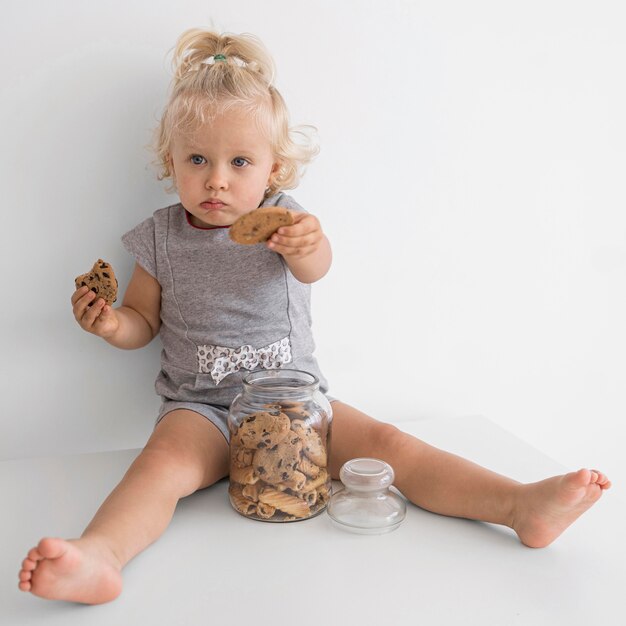 Adorable baby playing with food