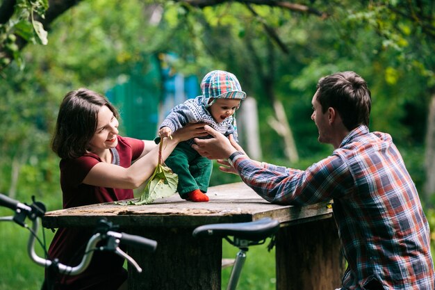 Adorable baby with parents in park